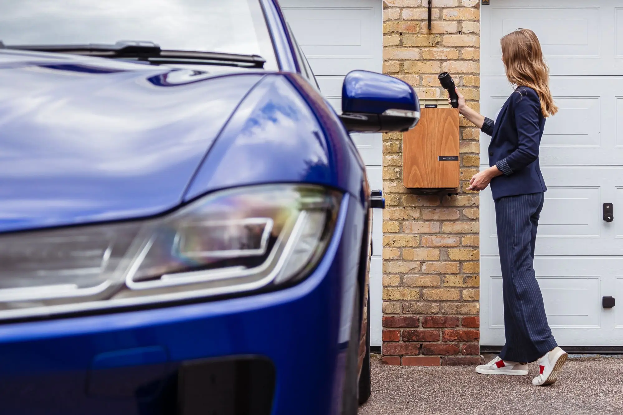 A car being charged at a wall-mounted home charging station